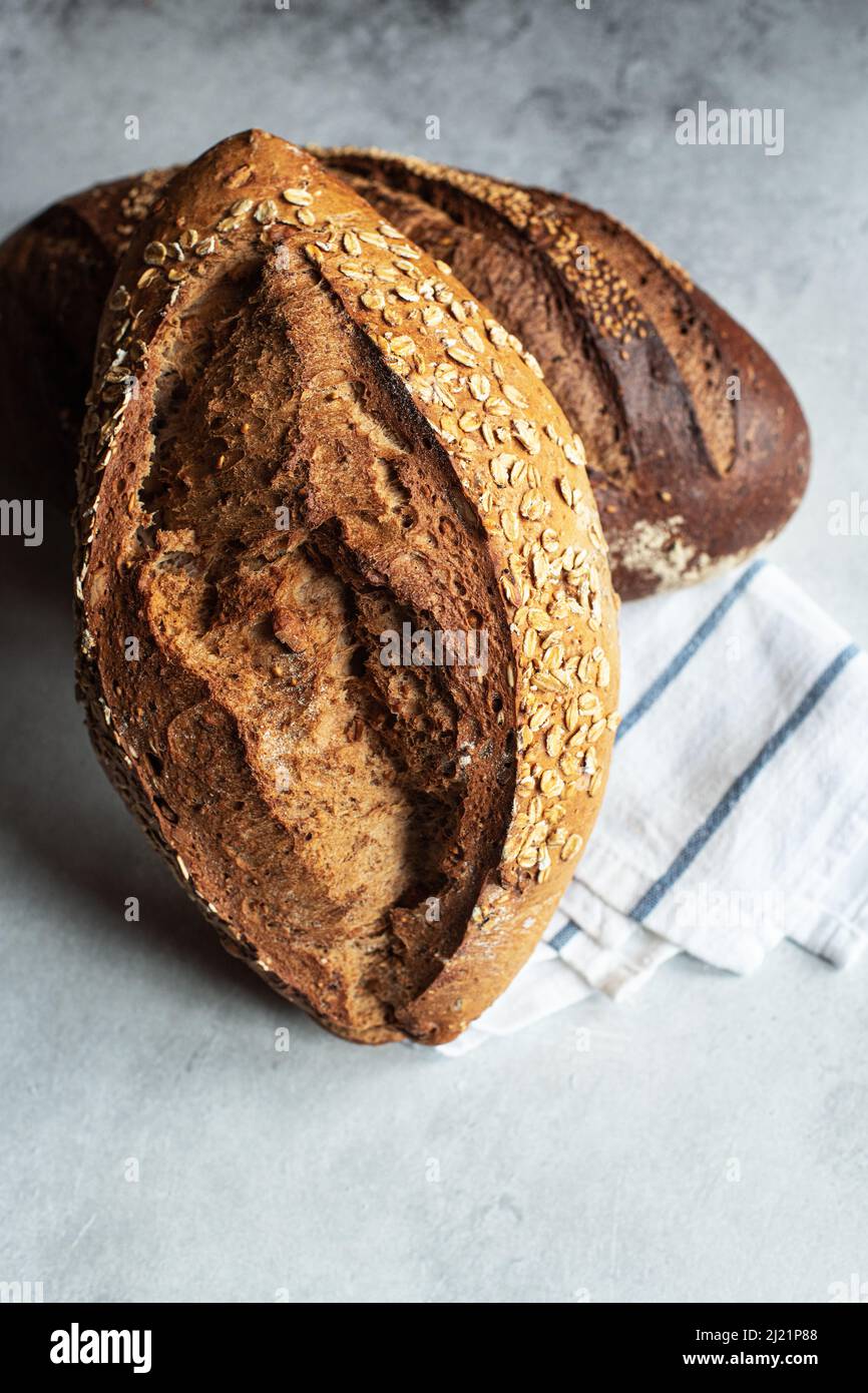 Two different sourdough bread on a gray background. Stock Photo