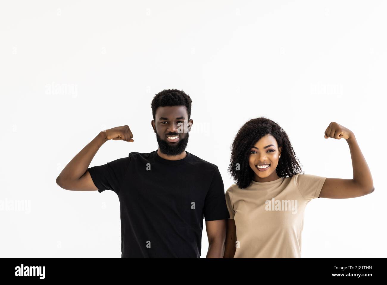 Portrait of a happy young african couple while standing together and ...
