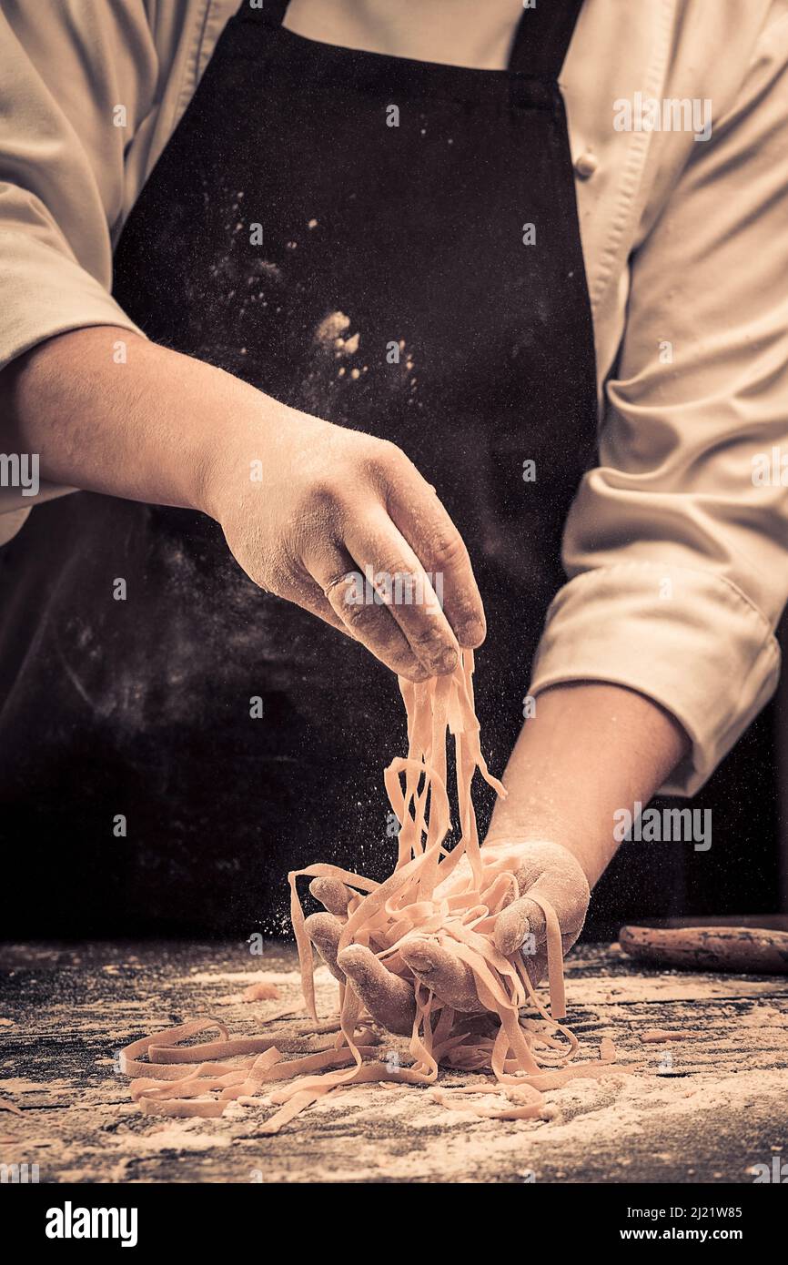 The chef makes fresh spaghetti from scratch. Stock Photo