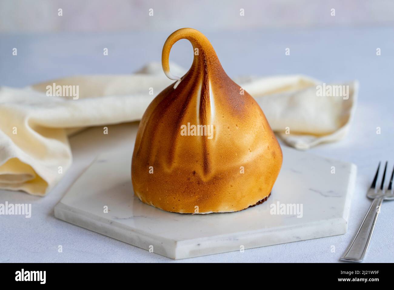 Cake with fruit filling on a white background. It's fried on the outside with a blowtorch. close up Stock Photo