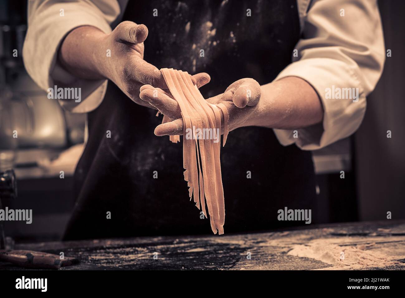 The chef makes fresh spaghetti from scratch. Stock Photo