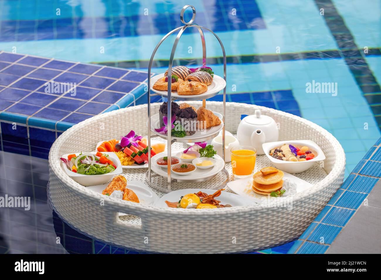Floating breakfast in luxury hotel resort. Breakfast in swimming pool at villa Stock Photo