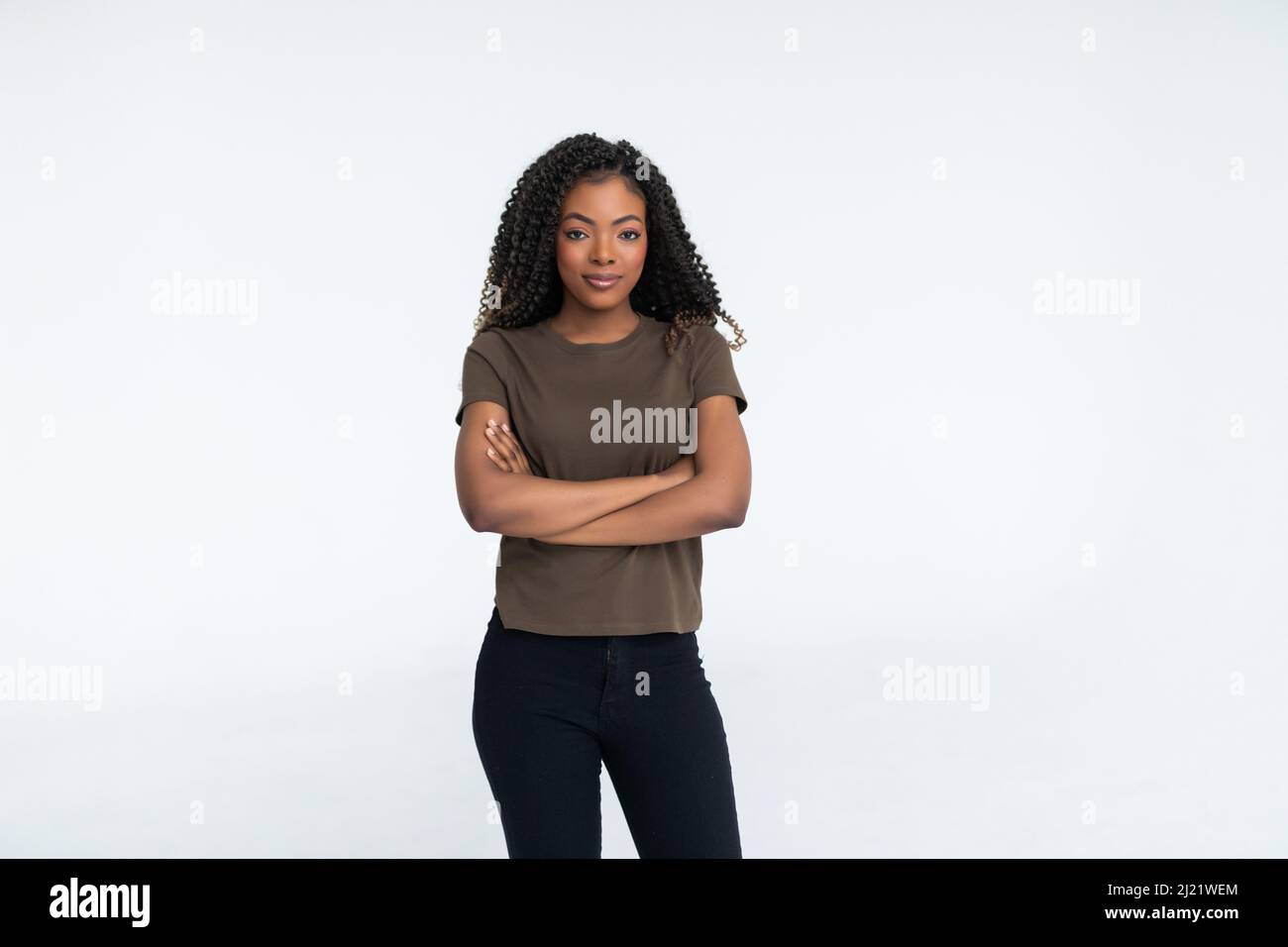 Portrait of a african woman with arms folded standing over gray ...