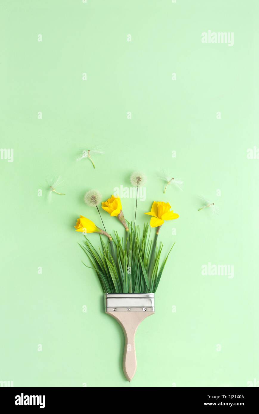 Paint brush with spring daffodils and dandelions Stock Photo