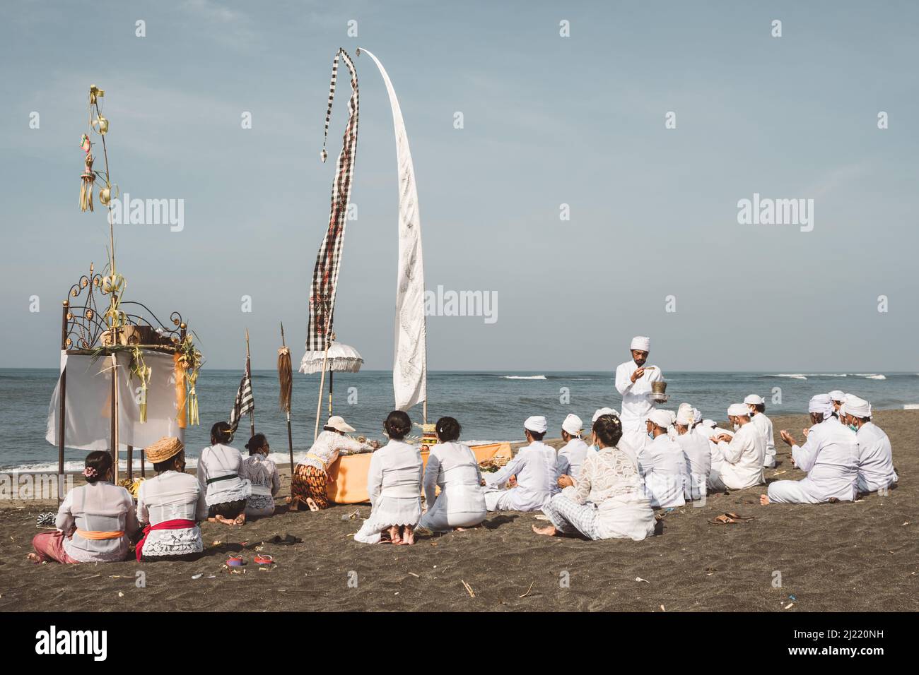 Balinese Hindu praying by the ocean. Balinese Hindus perform ...