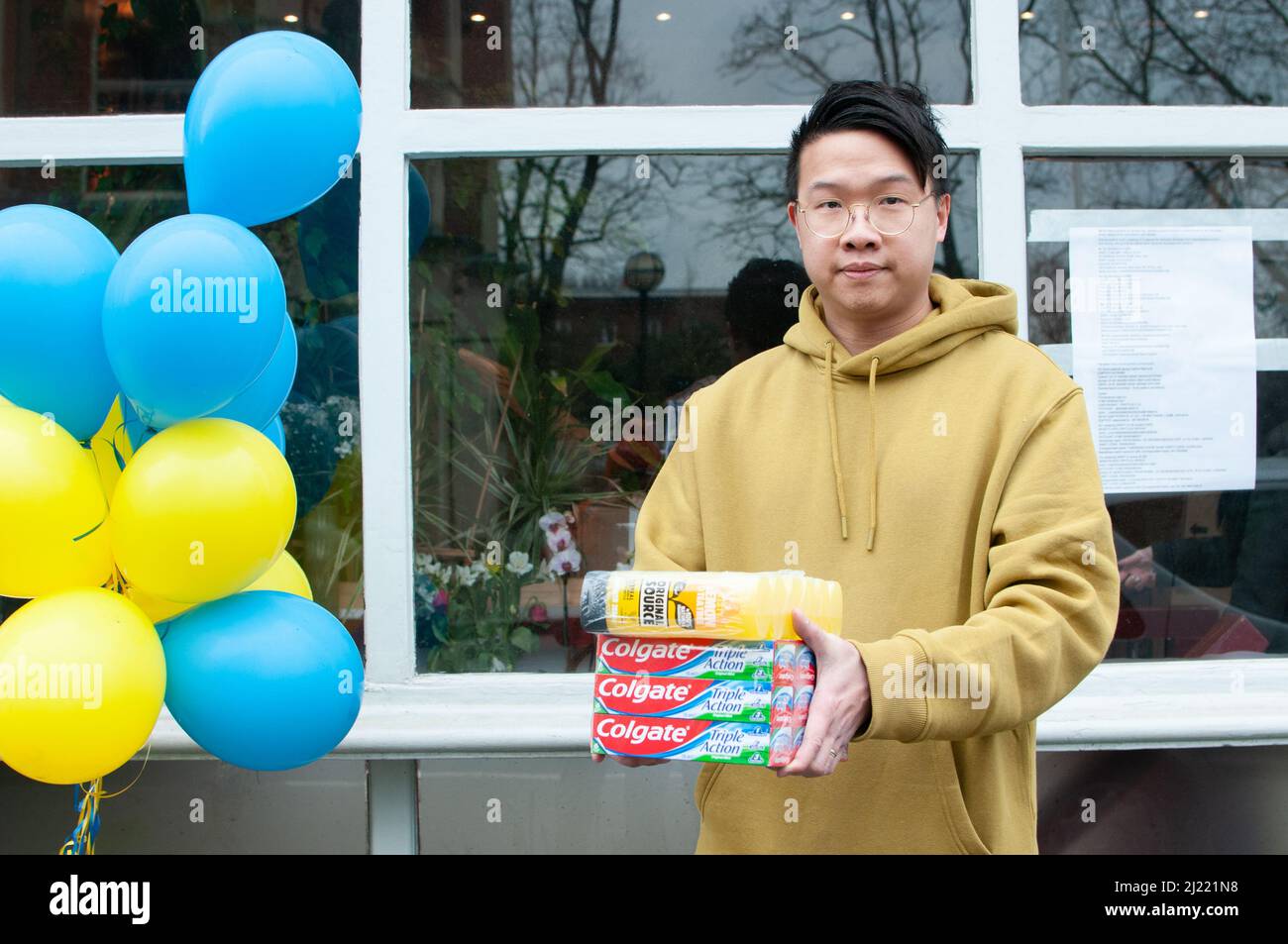 Jeffrey Lau (aged 32) from Hong Kong outside Prosperity restaurant, Twickenham, UK. The cafe has become a hub for donations for Ukraine since the start of the war on 24th February 2022.. 'We like to help those in need under totalitarian rule. We have a similar background - a totalitarian government. Same as in Honk Kong two years ago - s fight for freedom'. Credit: Tricia de Courcy Ling/Alamy Live News Stock Photo