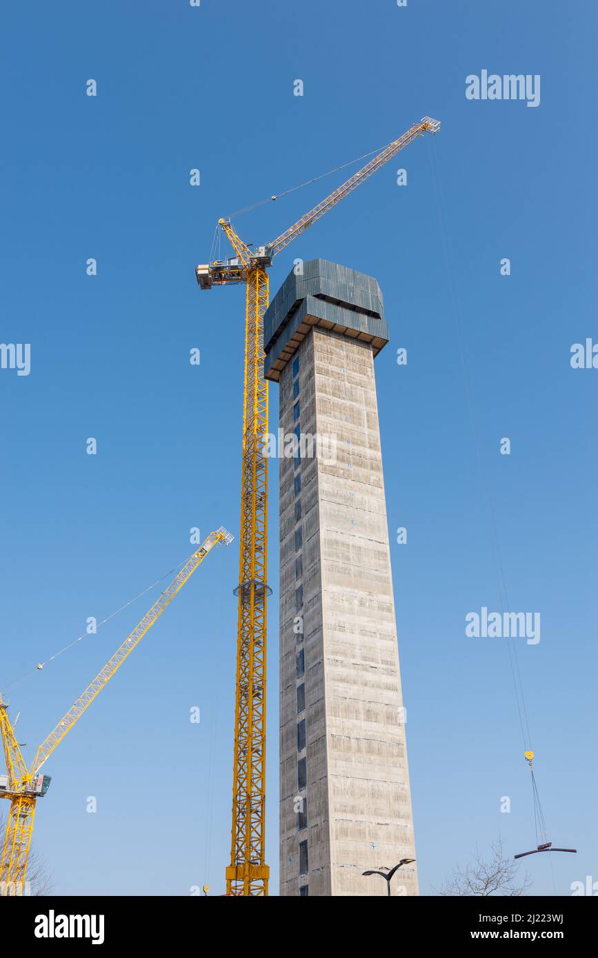 Construction of tall concrete central column of a new building with crane next to it in the centre of birmingham Stock Photo