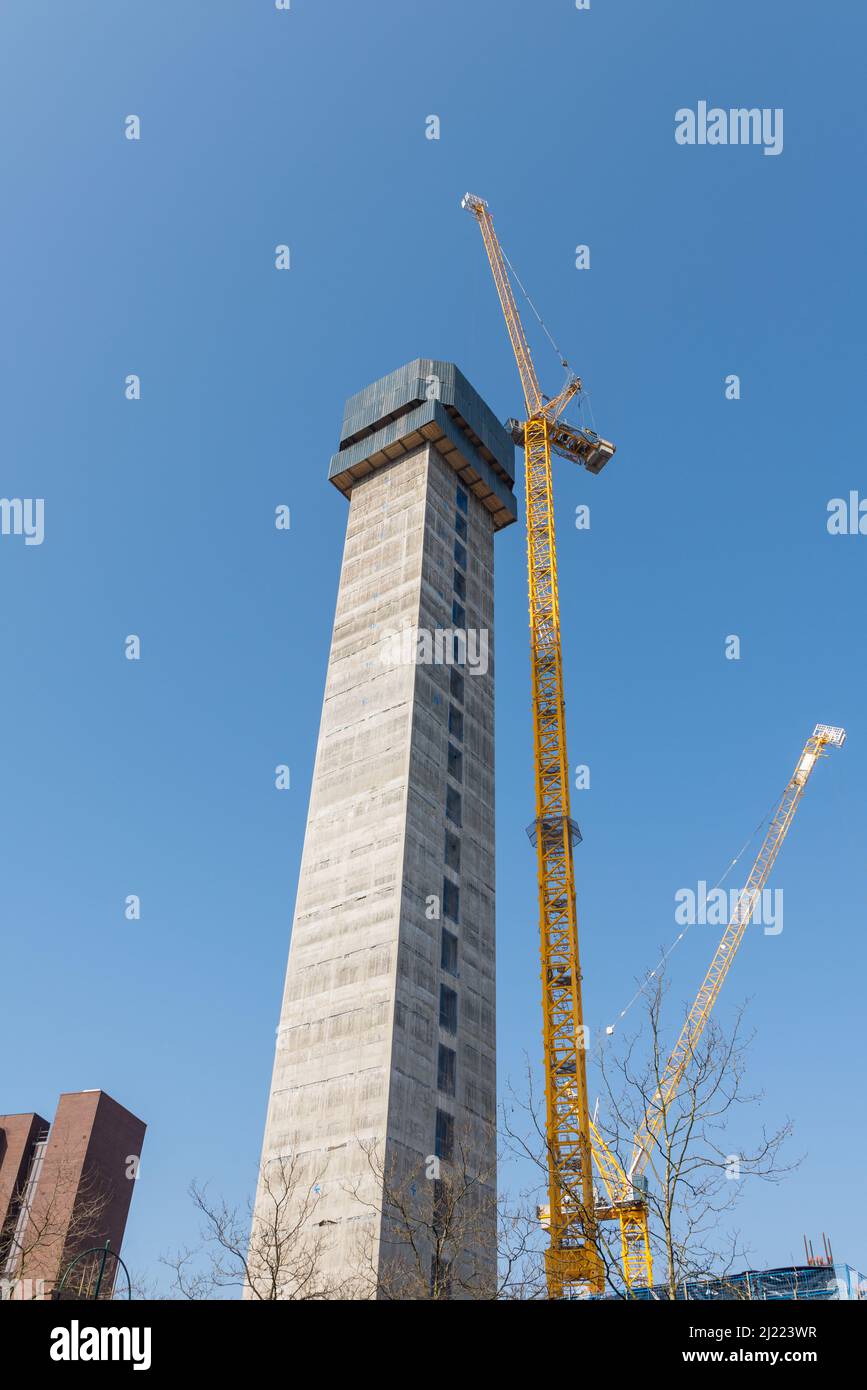 Construction of tall concrete central column of a new building with crane next to it in the centre of birmingham Stock Photo