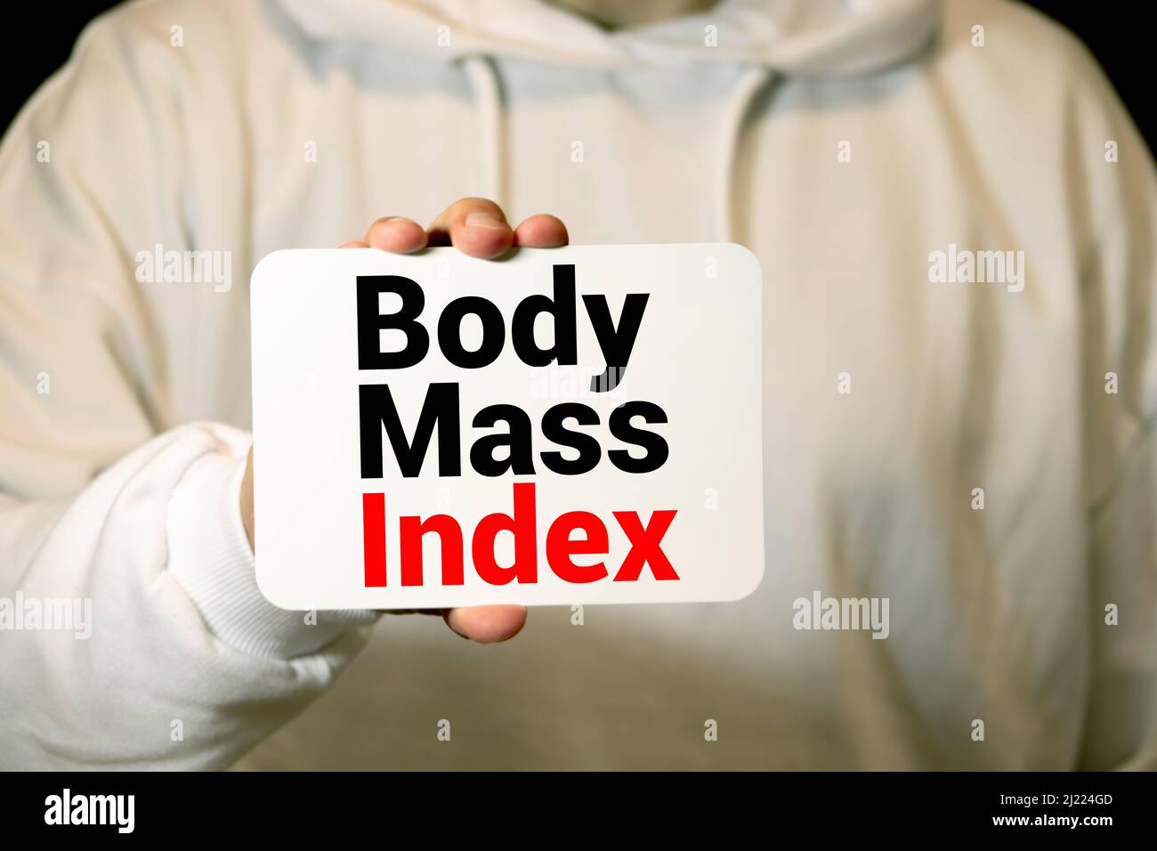 Body Mass index text on notebook with delicious green apple, measure