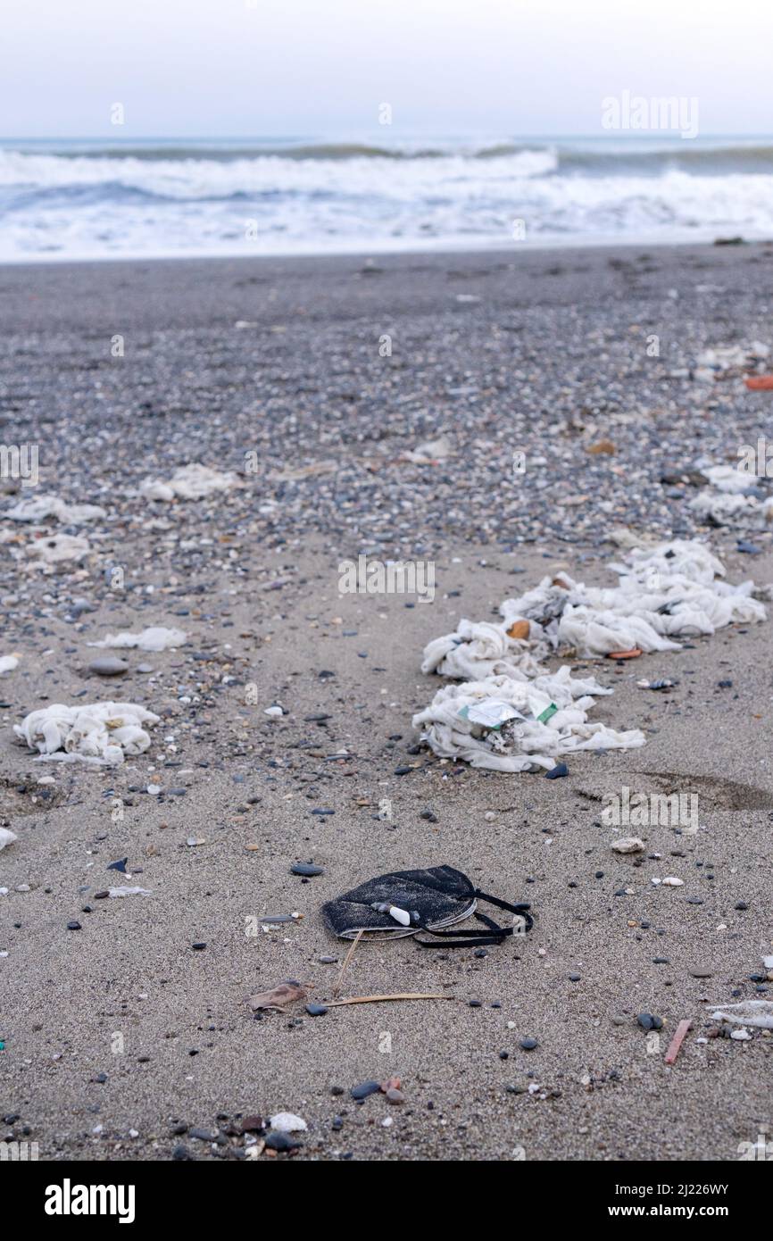 Beach full of garbage, wet wipes and waste that people throw in the toilet. Concept of ocean pollution and environmental destruction, Málaga, Spain. Stock Photo