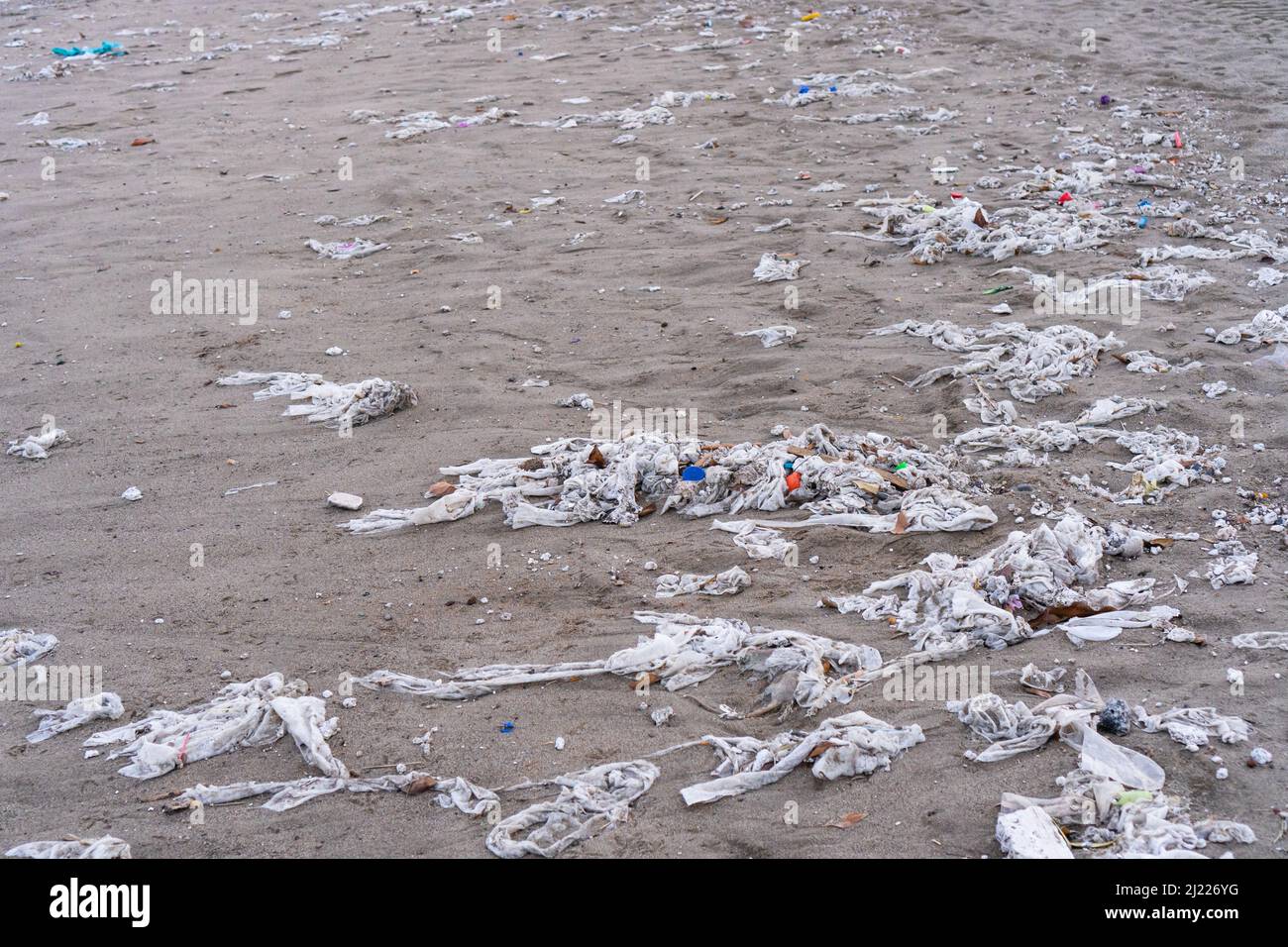 Beach full of garbage, wet wipes and waste that people throw in the toilet. Concept of ocean pollution and environmental destruction Stock Photo