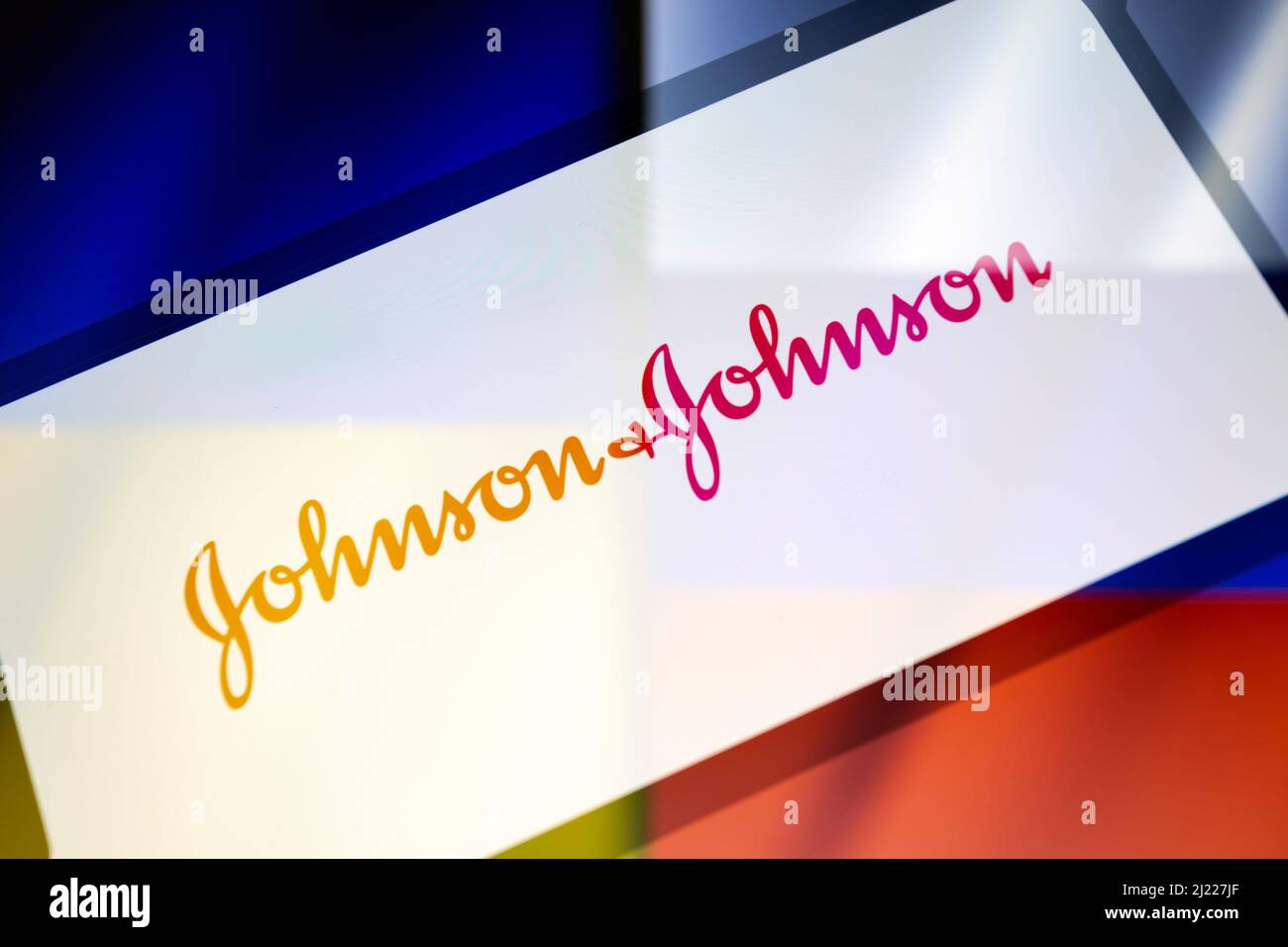 Asuncion, Paraguay. 29th Mar, 2022. Illustration: In-camera multiple exposure image shows logo of Johnson & Johnson on a smartphone backdropped by displayed cropped waving flags of Ukraine and Russia. (Credit Image: © Andre M. Chang/ZUMA Press Wire) Stock Photo