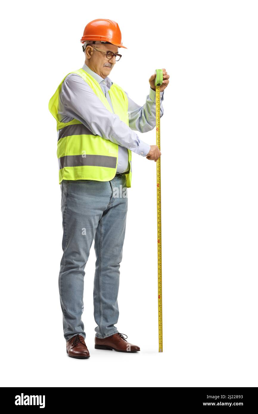 Full length shot of a mature male engineer measuring with a steel tape isolated on white background Stock Photo