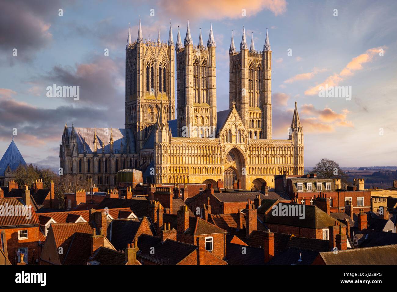 Lincoln Cathedral or Lincoln Minster behind the rooftops of the City of Lincoln Lincolnshire England UK GB Europe Stock Photo
