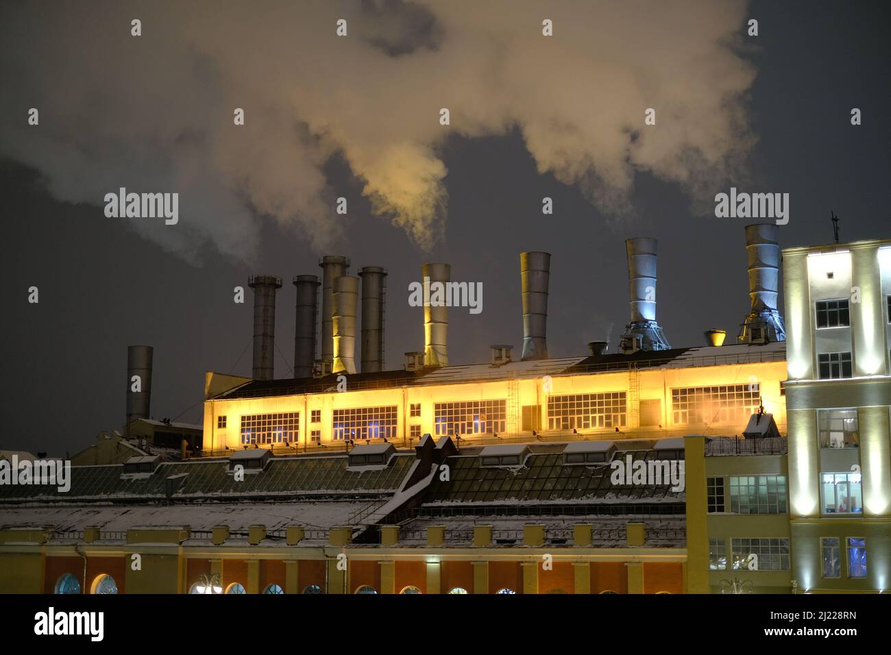 The view of the smoke coming from the factory chimneys. Stock Photo