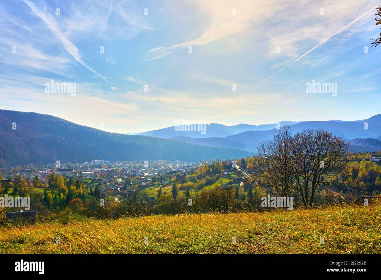 Mountain range and village in autumn colors and blue sky Stock Photo ...