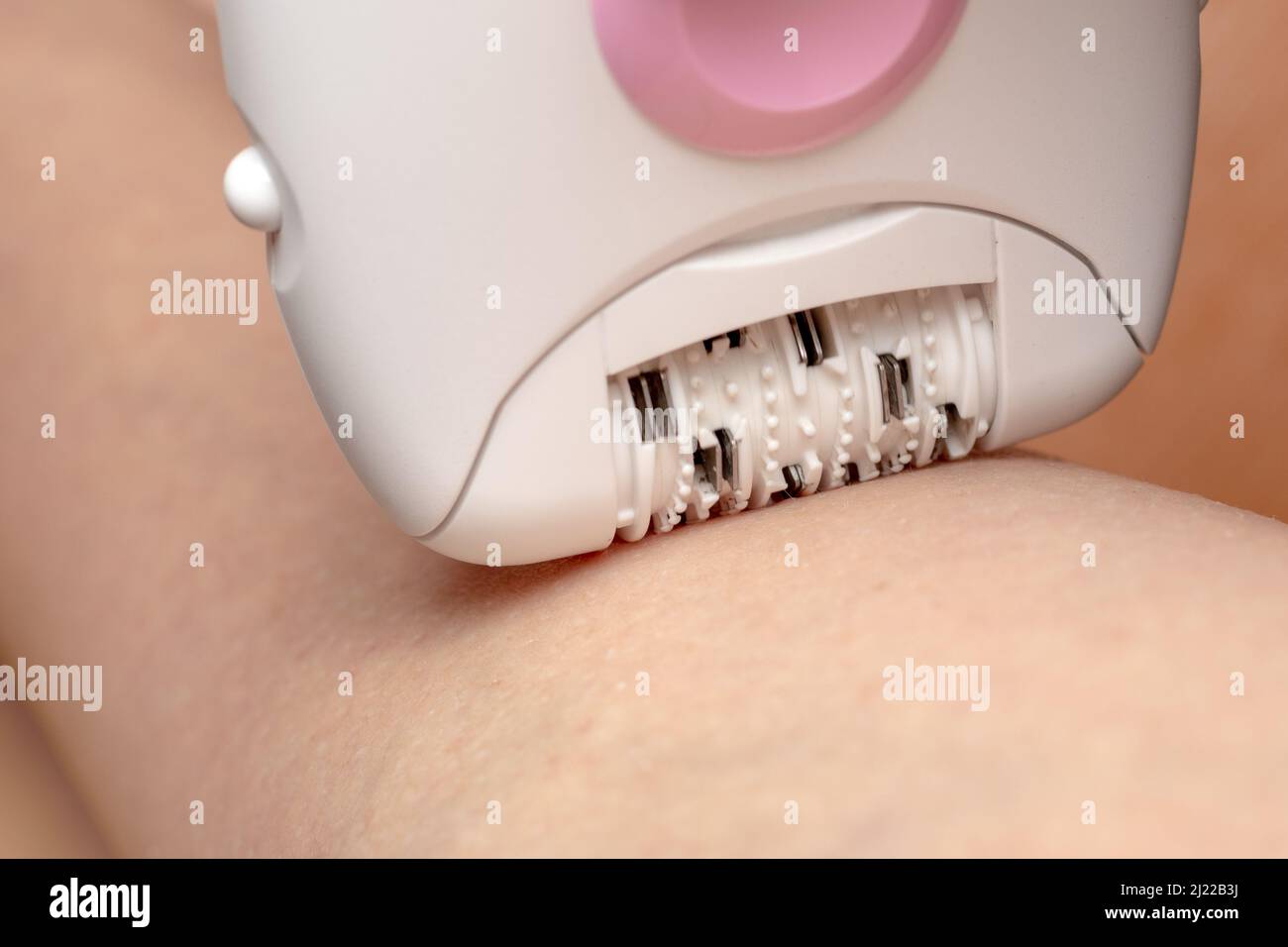 Skin Care and Health. Hair Removal. Woman Epilating Leg, White Electric