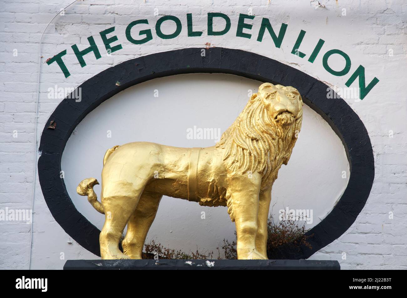 Figure of a gilded lion above the entry to The Golden Lion pub and hotel. The least fearsome representation of the king of the jungle in Weymouth. UK. Stock Photo