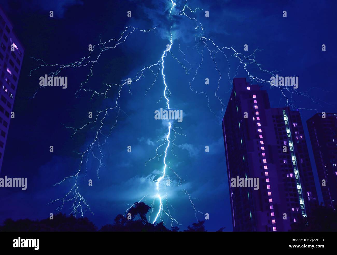 Pop Art Surreal Style of Incredible Lightning Strikes in Cobalt Blue Urban Night Sky Stock Photo