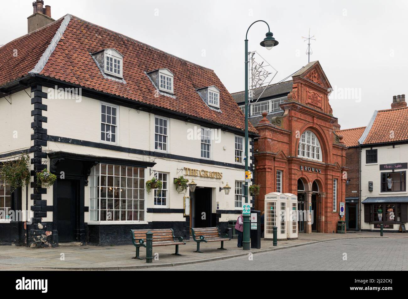 View from Saturday Market of English public house and department stores, and traditional telephone kiosks and benchs, Beverley, UK. Stock Photo