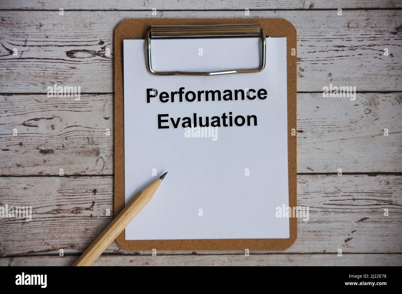 Top view of performance evaluation text on notepad. Stock Photo