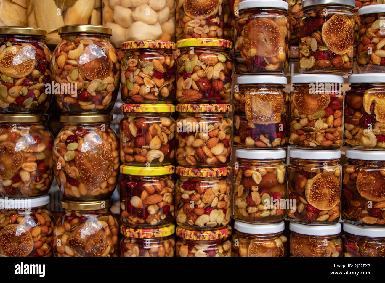 Nuts with honey in glass jars. Harvest of nuts. Delicacy and Healthy food.  Homemade preservation in autumn Stock Photo - Alamy