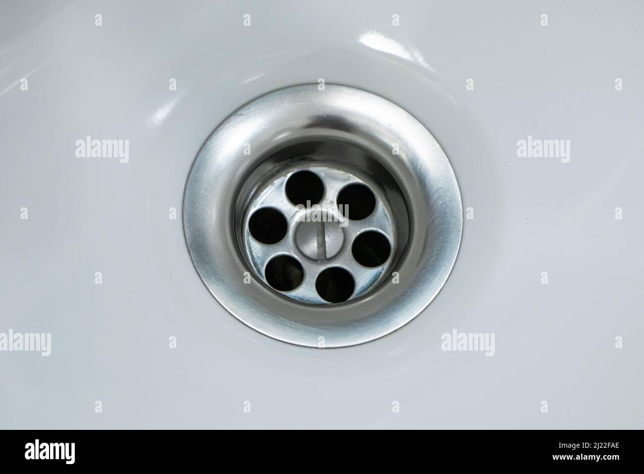 Standard round drain hole in white domestic sink Stock Photo Alamy