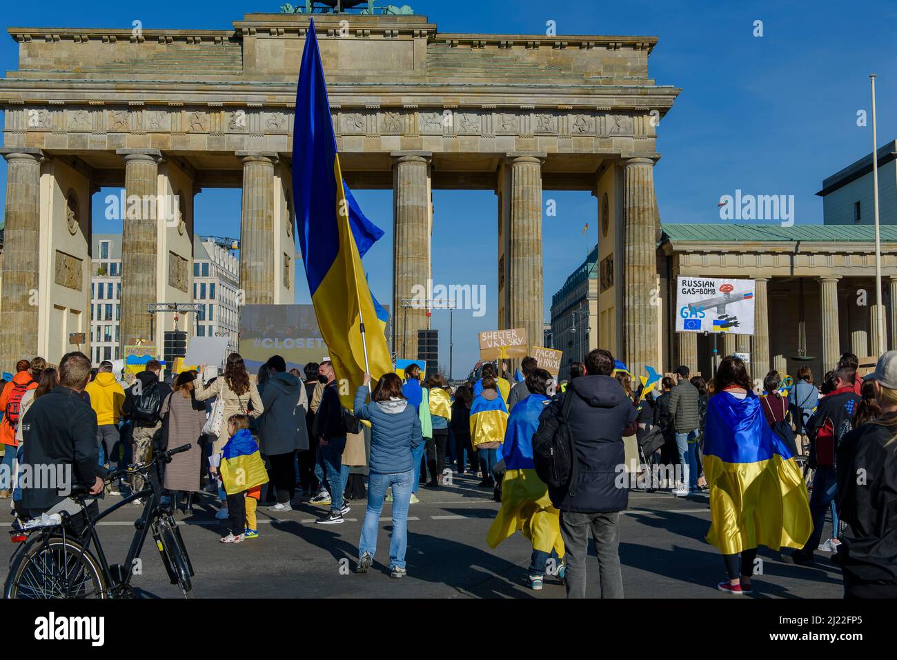 People in front of the Brandenburg Gate in Berlin Germany demonstrate against the war in Ukraine Stock Photo