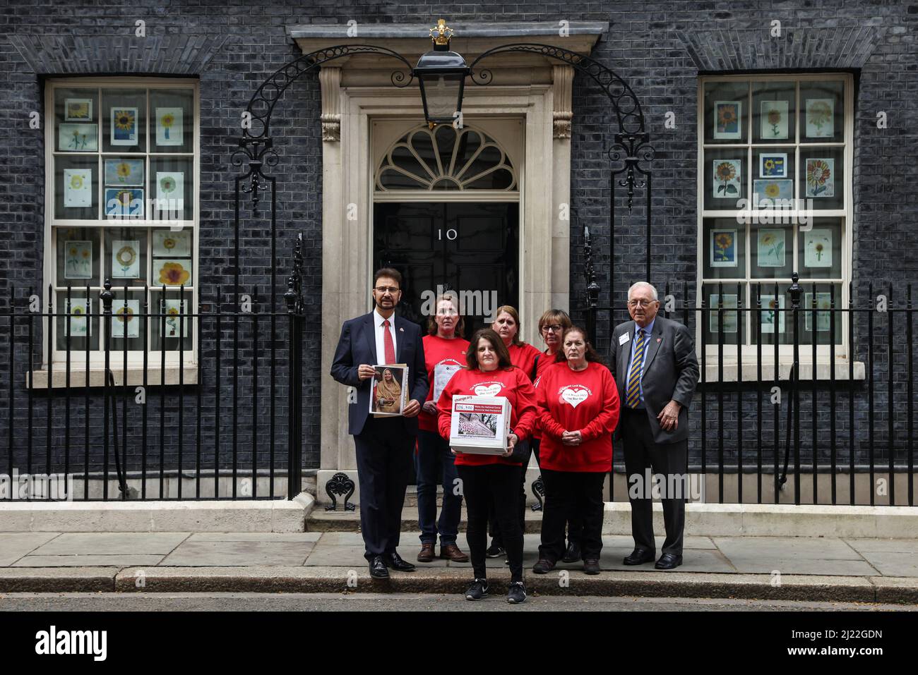 Members of the COVID-19 Bereaved Families for Justice UK stand outside 10 Downing Street on national day of reflection to mark the 1 year anniversary of The National Covid Memorial Wall creation, in London, Britain March 29, 2022. REUTERS/Tom Nicholson Stock Photo