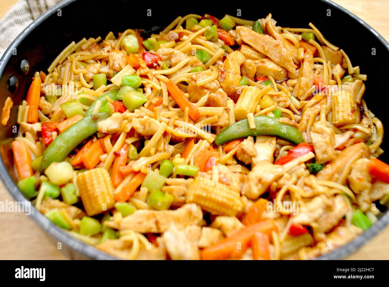 Teriyaki Chicken Vegetable Stir Fry with Thin Noodles in a Pan Stock