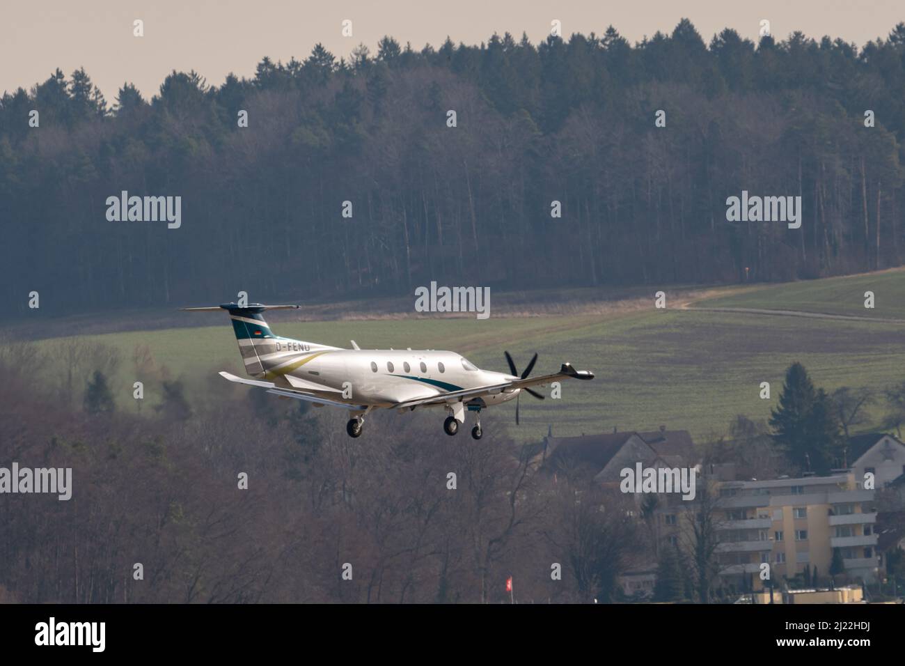Zurich, Switzerland, February 24, 2022 Pilatus PC-12 propeller plane on its final approach on runway 14 Stock Photo