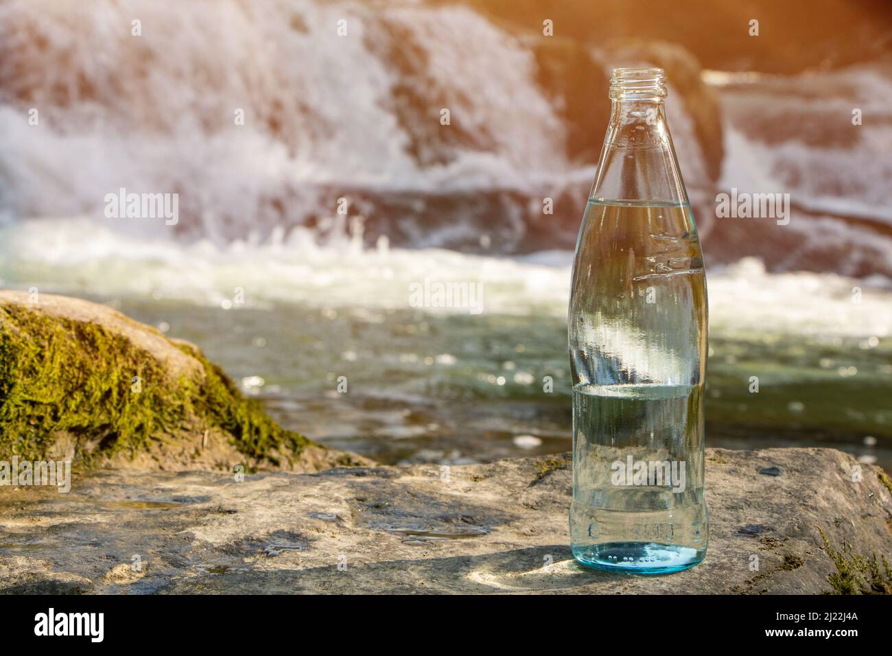 Natural drinking water in a bottle on nature background river Stock Photo Alamy