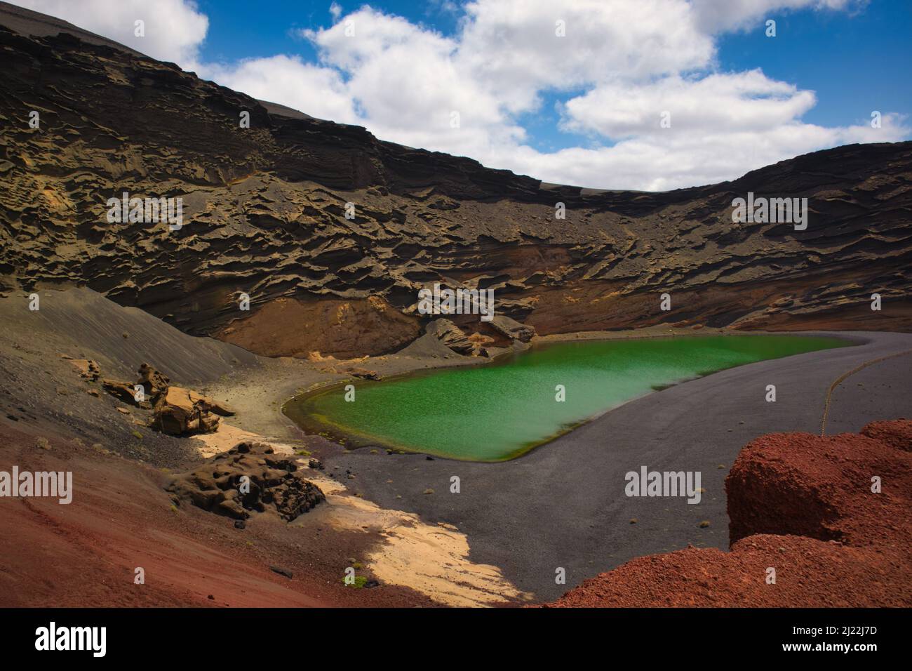 The Green Lagoon in Lanzarote. El Golfo is a lake of an unusual green color on the island of Lanzarote, formed in the crater of an old volcano and it Stock Photo