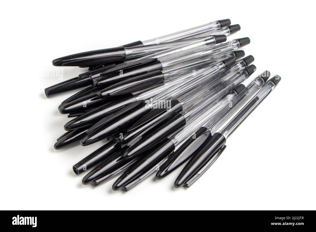 Lots of black ballpoint pens on a white background, multicolored
