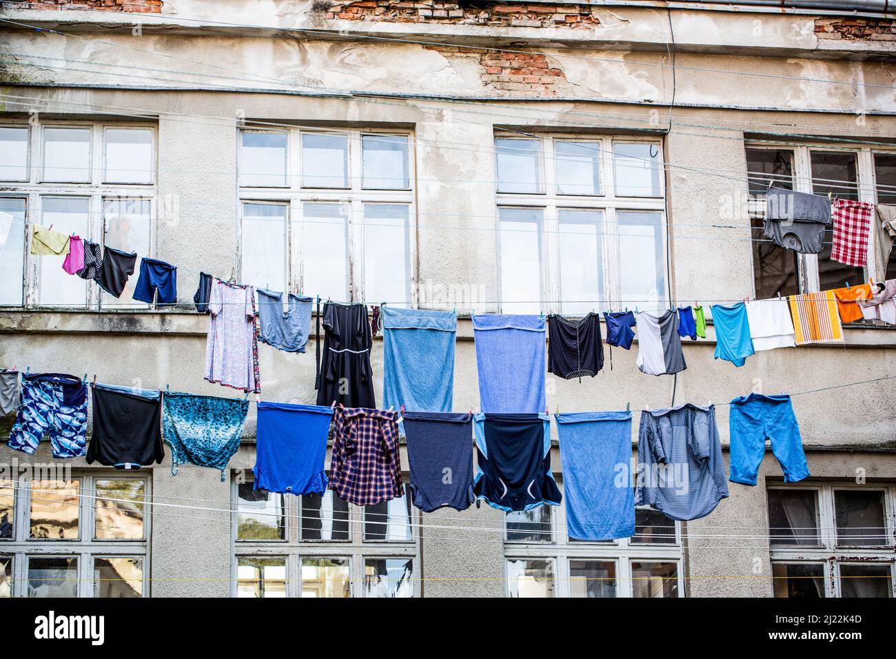 Washed clothes drying outside of an old house. Washed clothes drying