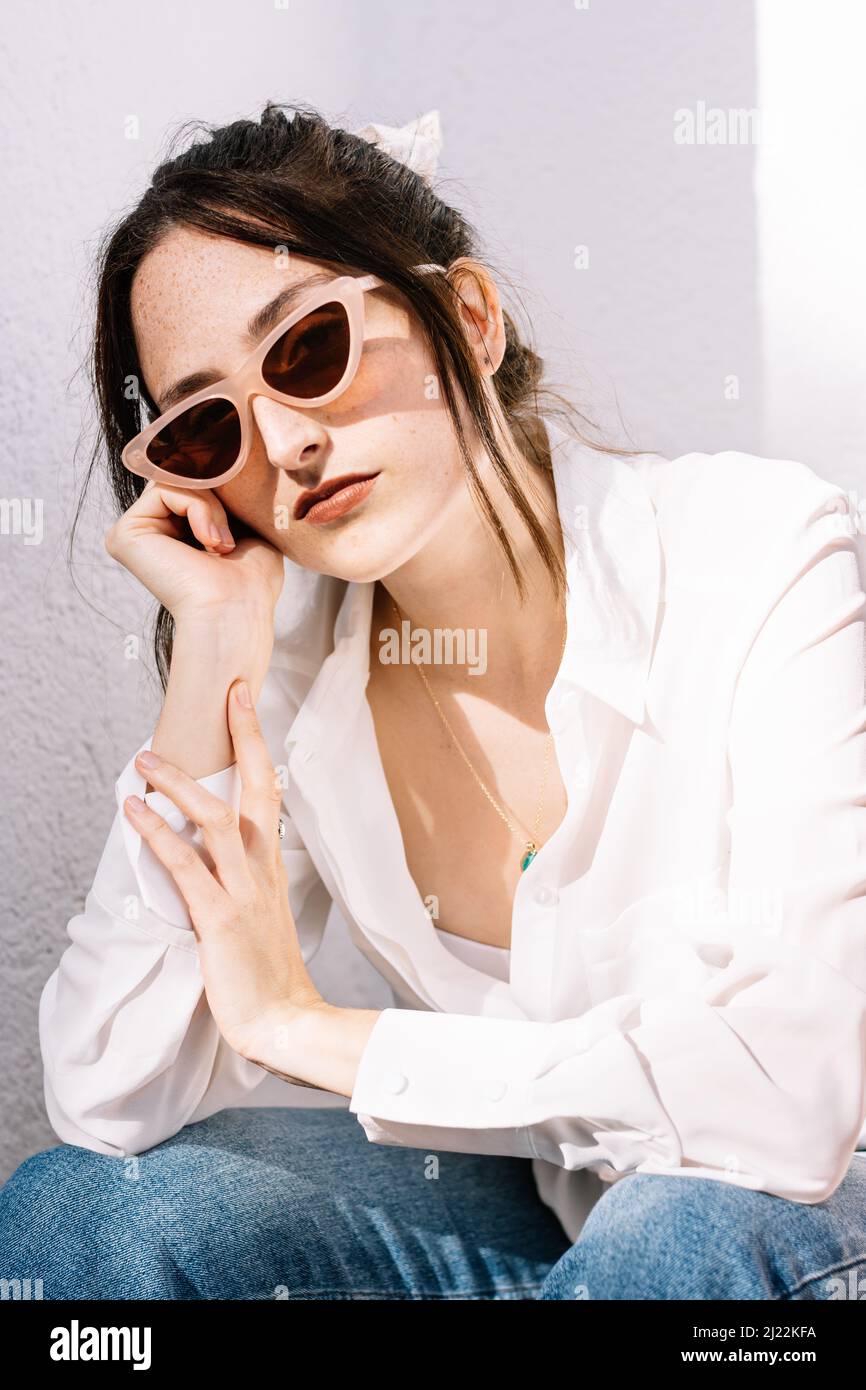 Portrait of bored young woman with sunglasses Stock Photo