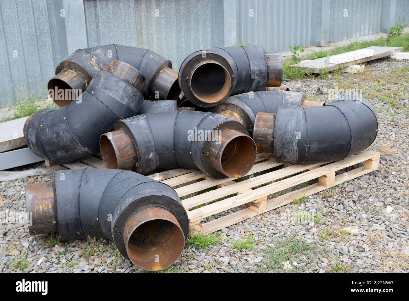 Angle elements of a pipes for heating system in a heatinsulating material Stock Photo Alamy