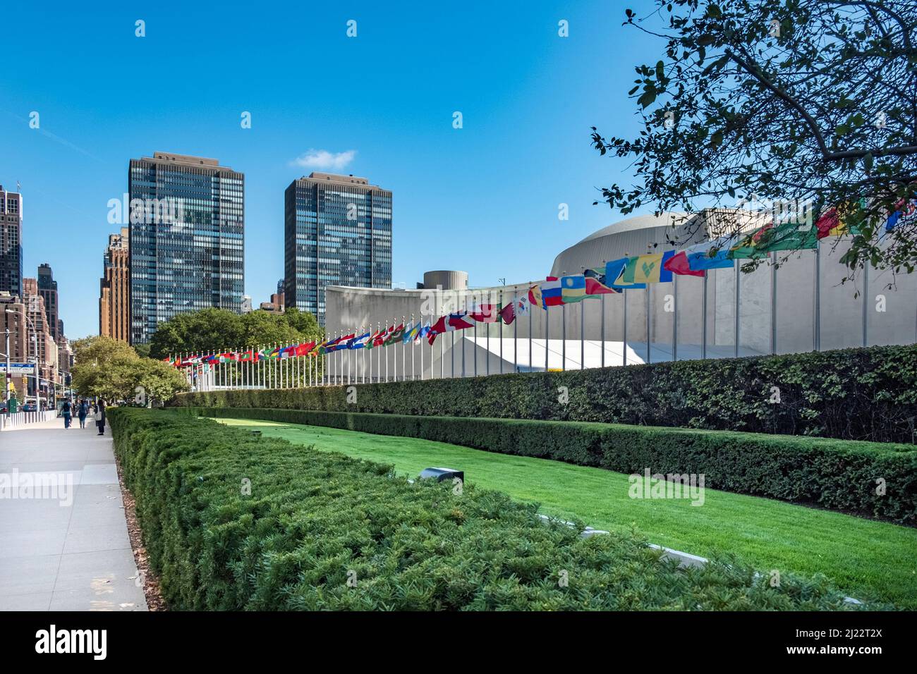 NEW YORK, USA - OCT 4, 2017:   UN Nations building with flags of participating countries in sun. Stock Photo