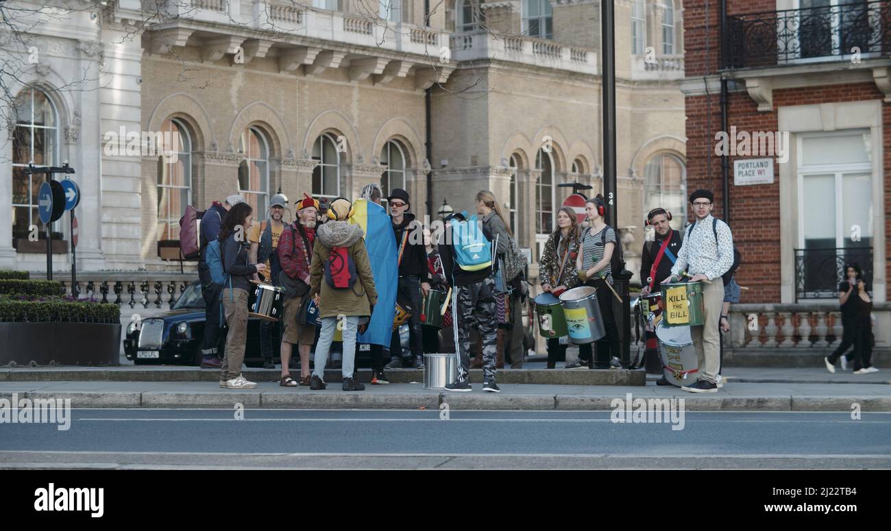 London, UK - 03 19 2022:  Group of Extinction Rebellion climate protest percussionists with drums, at Portland Place, for ‘March Against Racism'. Stock Photo