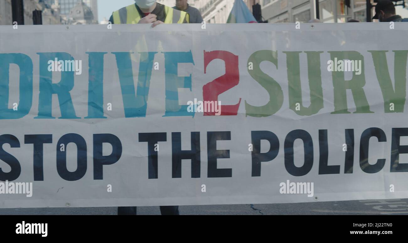 London, UK - 03 19 2022:  Protesters on Regent Street holding a banner, ‘Drive 2 Survive.  Stop The Police Bill’, for the yearly ‘March Against Racism'. Stock Photo