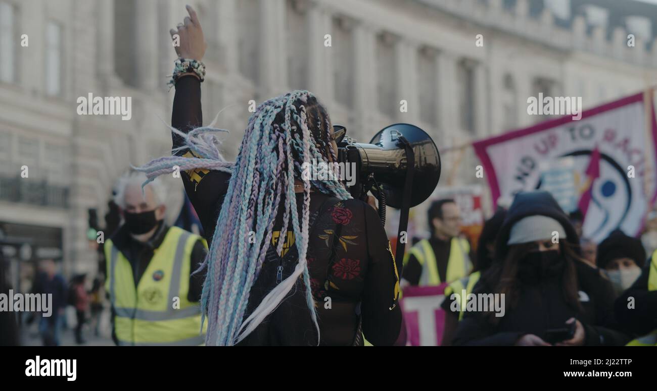 London, UK - 03 19 2022:  Black woman protester on Regent Street,  amongst a crowd of people, ‘March Against Racism’, ‘UN Anti Racism Day’. Stock Photo