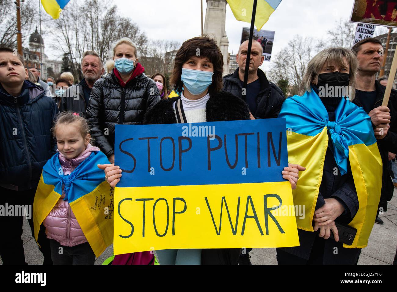 A woman holds a sign that reads 'Stop Putin, stop war' during a protest against the war in Ukraine in Madrid, Spain Stock Photo