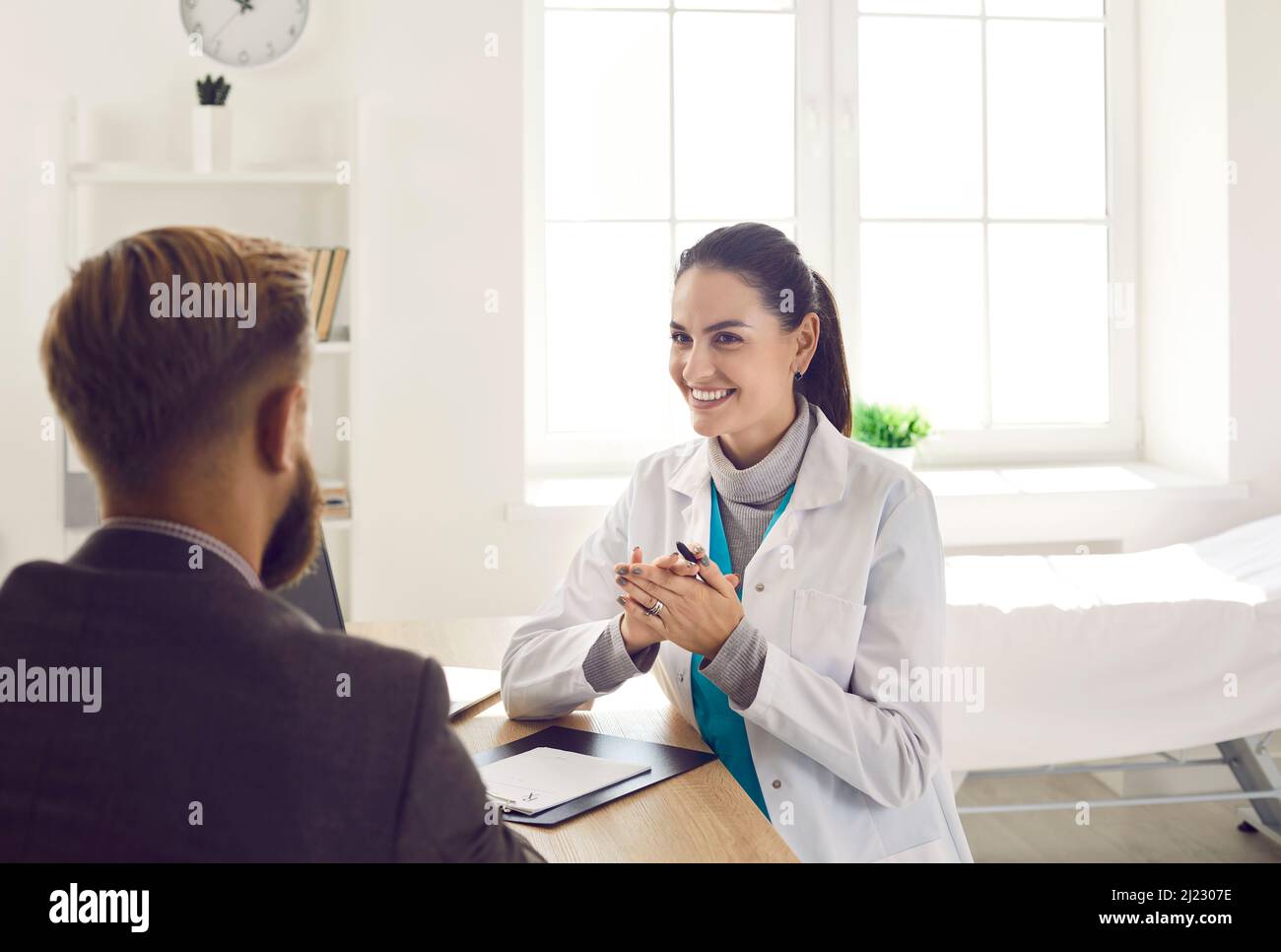 Smiling female doctor consult male patient Stock Photo