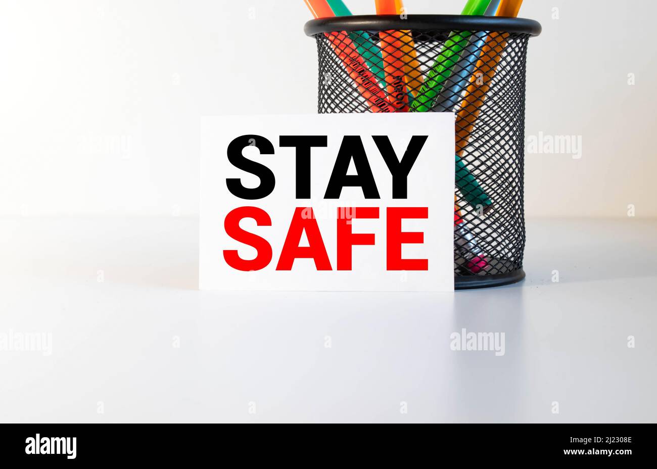 Stay safe text on card and hand holding it. Healthcare or prevention