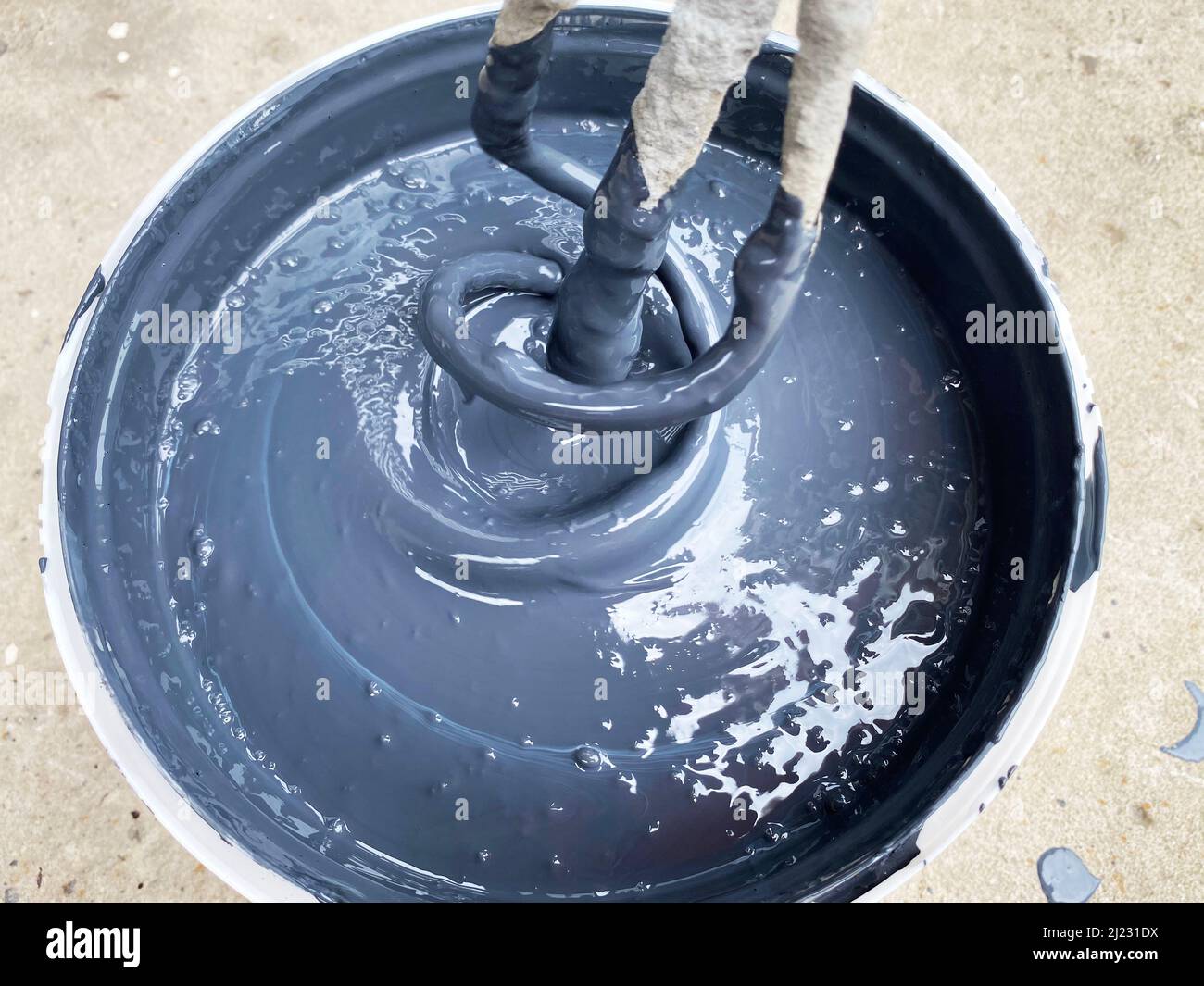 Building mixer for mixing paint. Mixing process Stock Photo Alamy