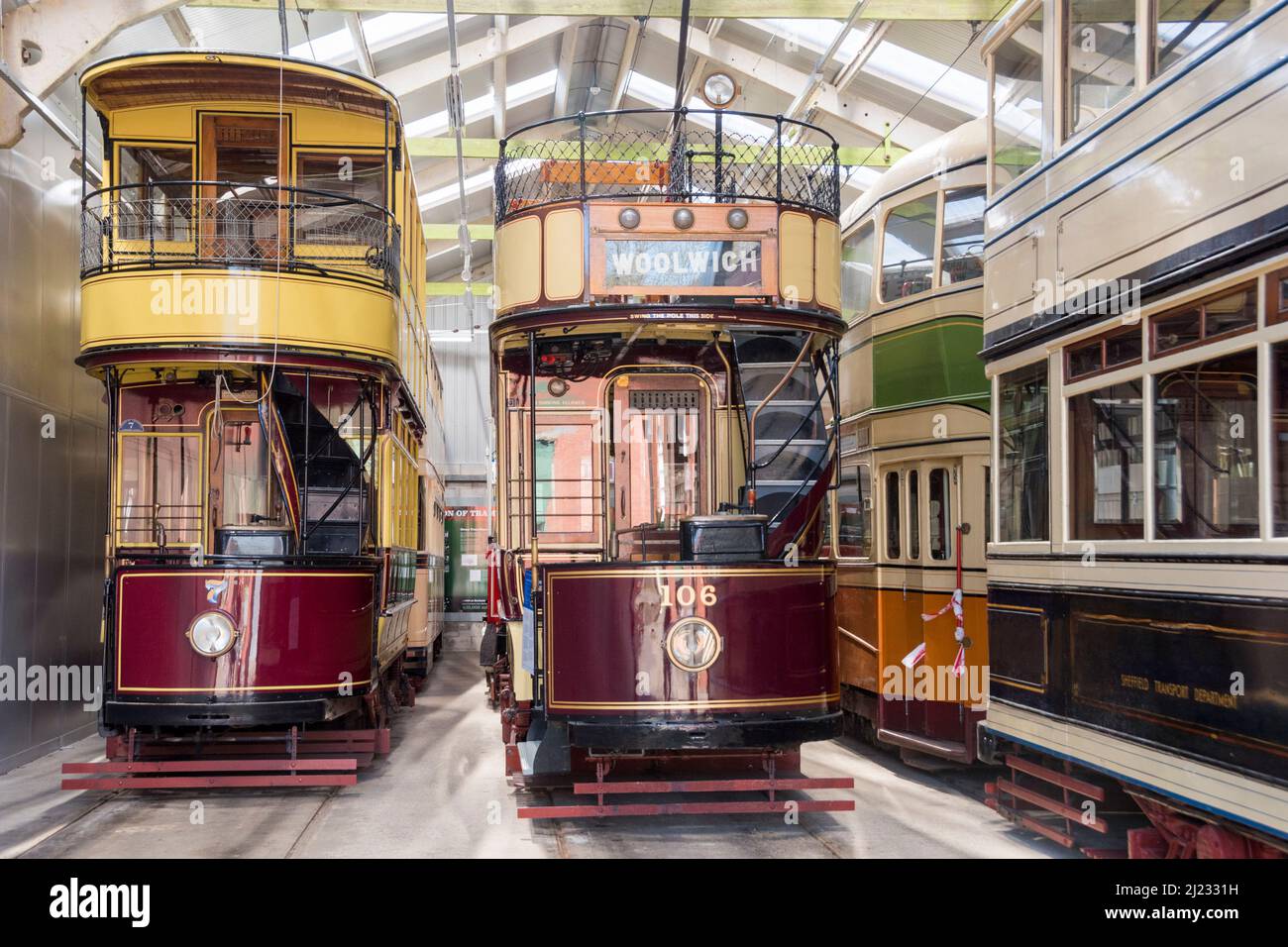 Derbyshire, UK – 5 April 2018: Beautifully restored vintage trams stored in the vehicle garage at Crich Tramway Village, the national tram museum Stock Photo