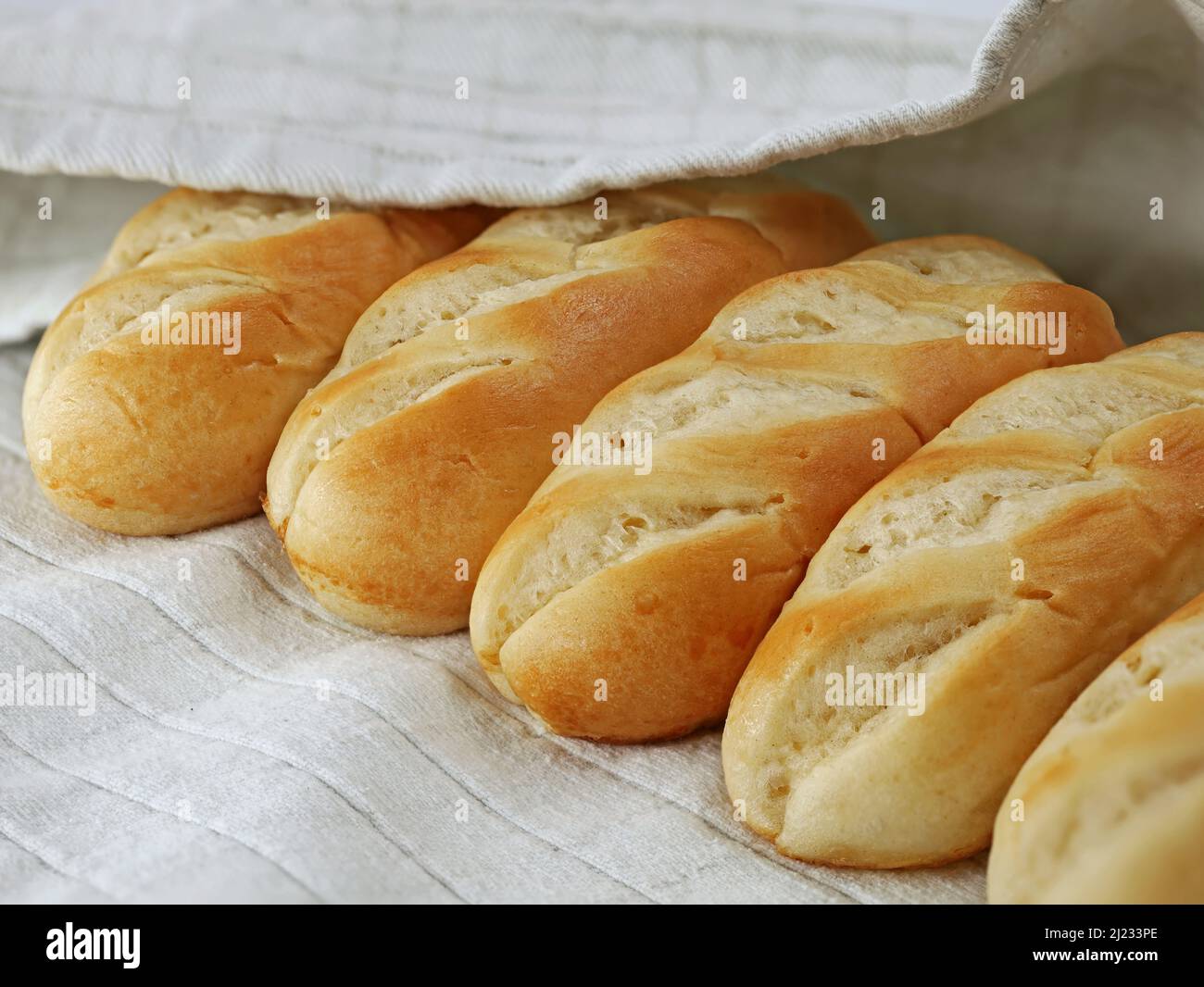 french milk bread buns on gray kitchen towel, close up of delicious french food Stock Photo