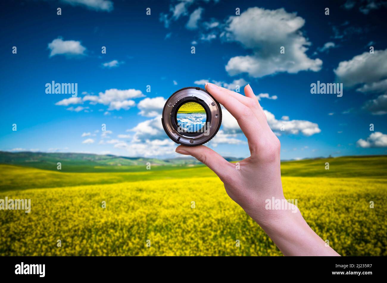Hand holds lens viewfinder against nature in Tuscany Stock Photo Alamy