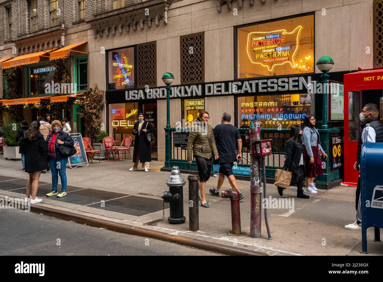 People walk past the USA Brooklyn Delicatessen in Midtown Manhattan in New York on Saturday, March 26, 2022.  The fast casual restaurant is part of the Fireman Hospitality Group. (© Richard B. Levine) Stock Photo