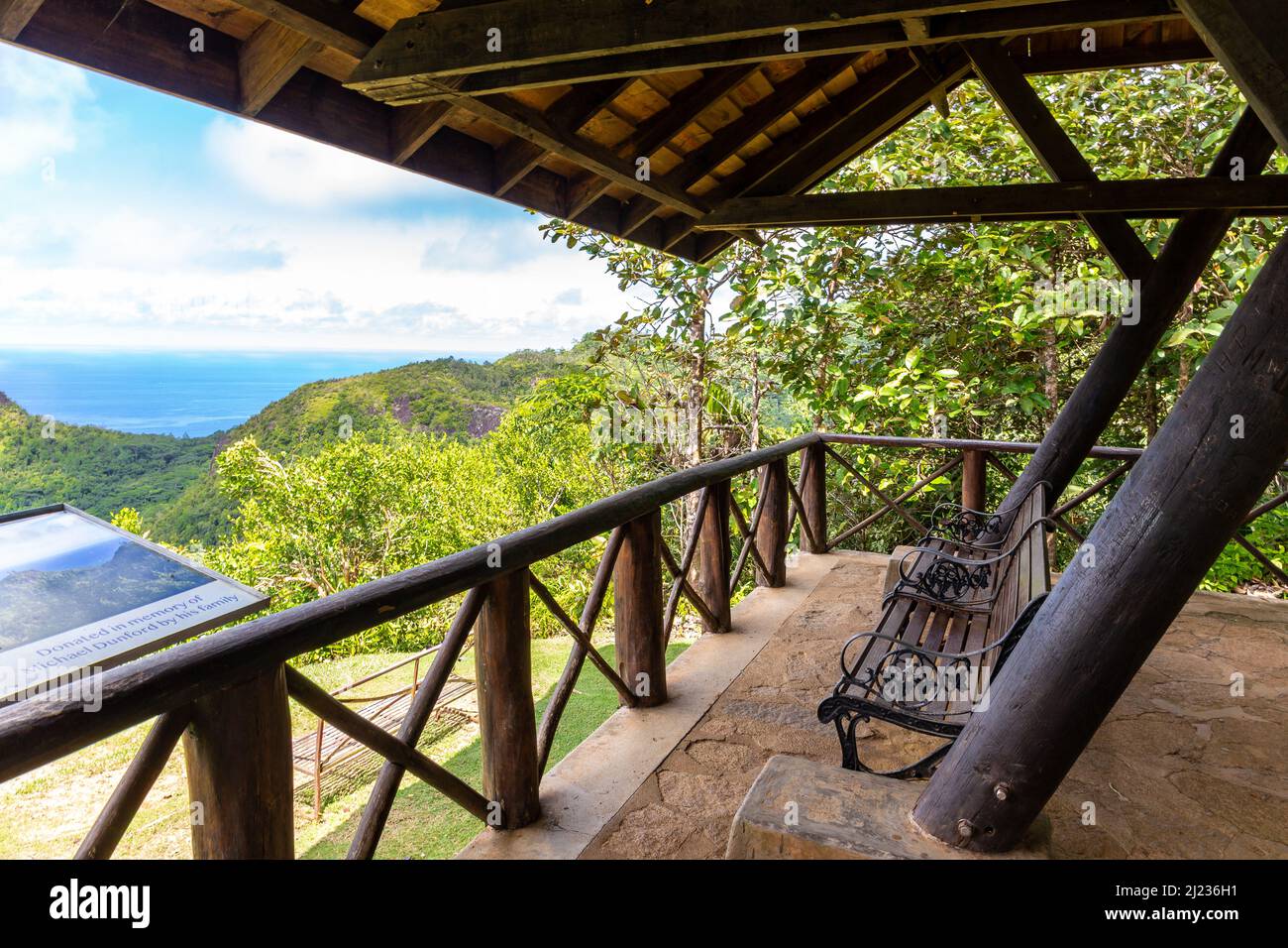 Mahe, Seychelles, 3.05.2021. Venn's Town - Mission Lodge wooden viewing platform with benches and panoramic map overlooking lush tropical forest. Stock Photo